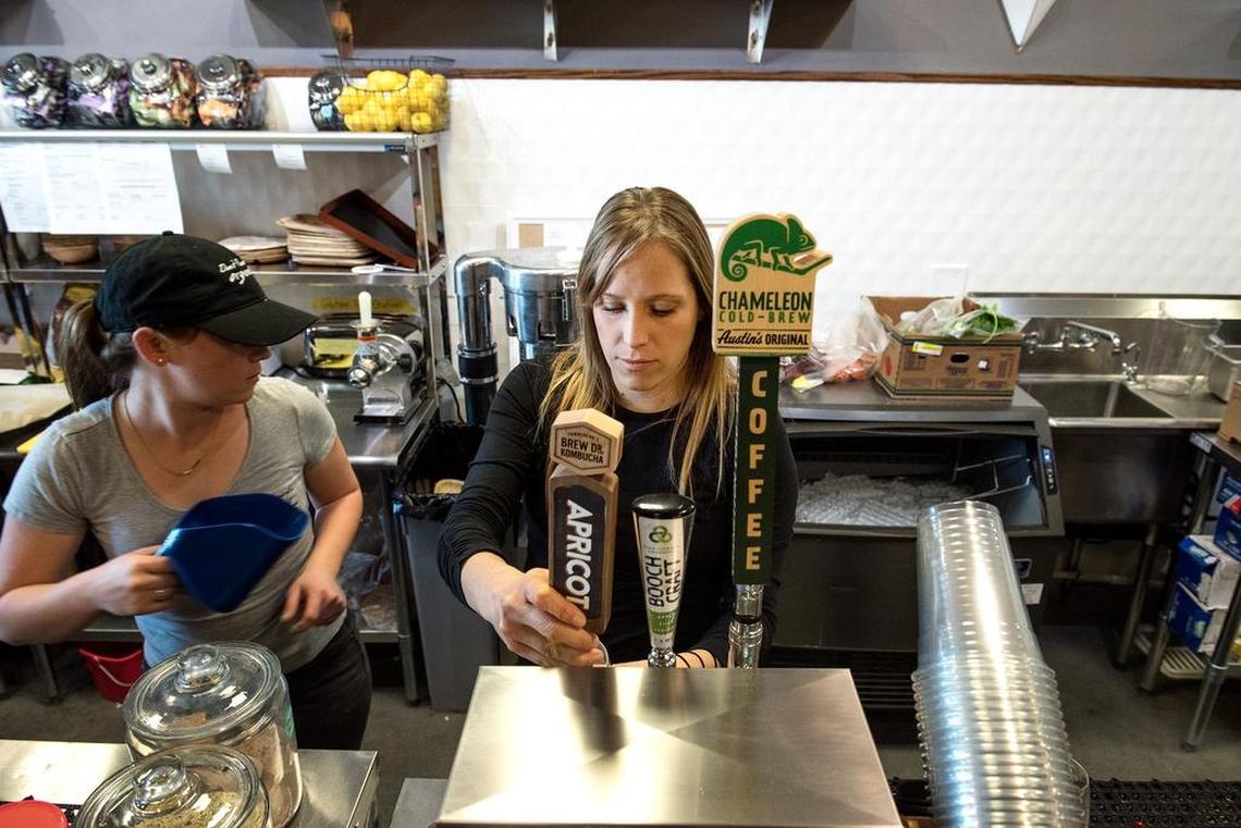 Katherine Bertolotti pours koumbucha on tap at Don’t Panic It’s Organic eatery in Hughson, Calif., Wednesday, Nov. 7, 2018.