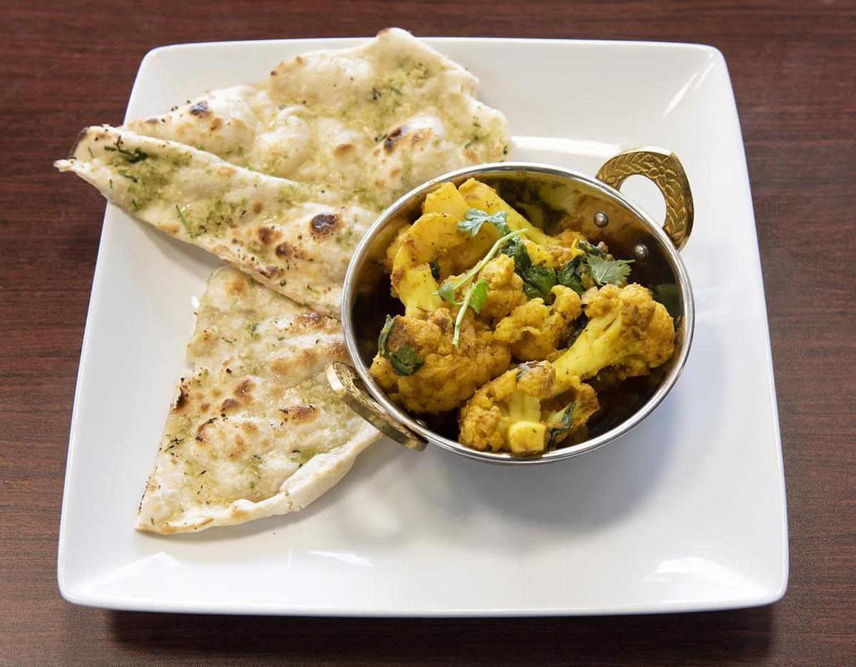 Allo Gobi, spiced cauliflower and potatoes, with garlic chili naan at Mother India Cuisine in Ceres, Calif., Saturday, Feb. 9, 2019.