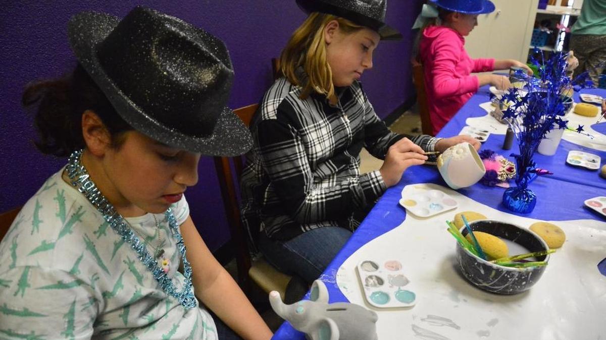 The Pottery Place & More, a ceramics, canvas and scrapbooking studio, opened last fall in north Modesto. Emily Flora (center) and Gianna Genasci (left) paints during a birthday party at the studio Saturday, March 3, 2018.
