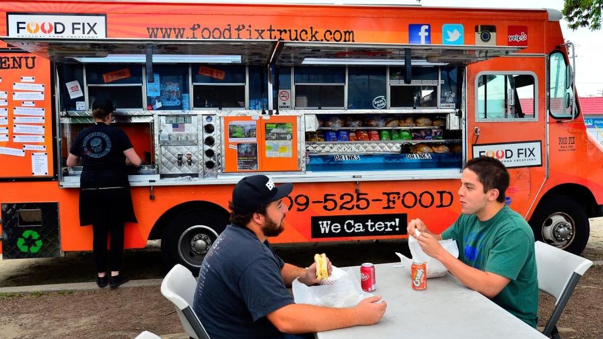 Jose Vallejo (right) & Michael Magee (left) enjoy a meal at the Food Fix Truck in Modesto California on March 18, 2017.