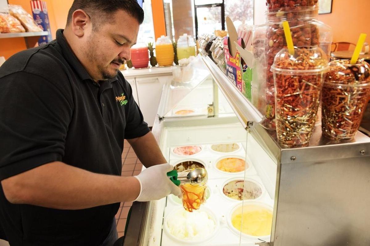 Owner Larry Rivera prepares a Mangonada at Mango Crazy in Village One Plaza in Modesto, Calif., Thursday, August 23, 2018. San Francisco’s Fisherman’s Wharf this fall.
