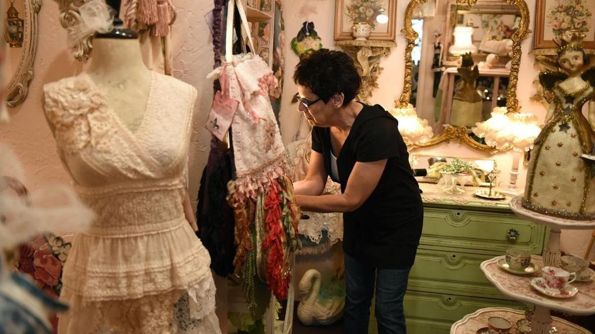 Manager Carol Squires works in the new boutique La Petite Bijoux in downtown Modesto on Thursday morning, Sept. 15, 2016.