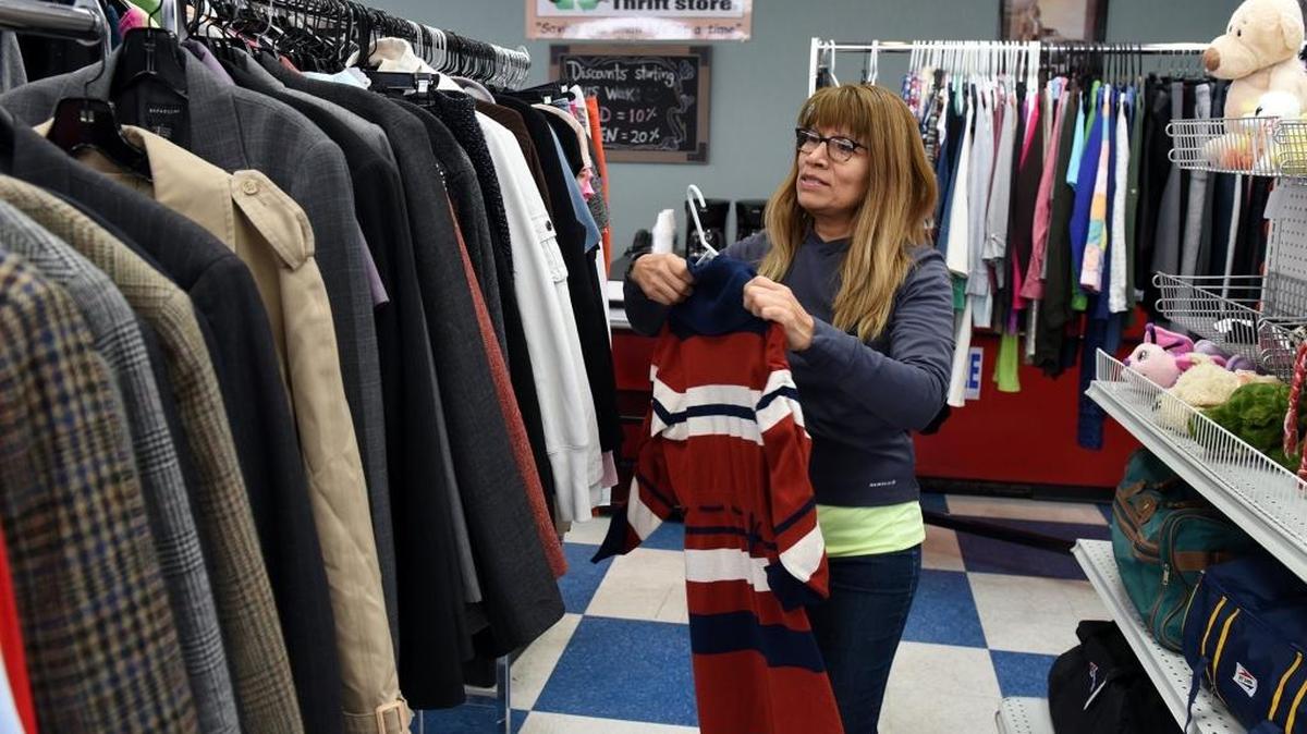 Nancy Callaway puts a dress on a rack Tuesday morning in the business Los Gatos thrift shop on McHenry Avenue in Modesto, Calif. Her business benefits Stanislaus County Animal Services.