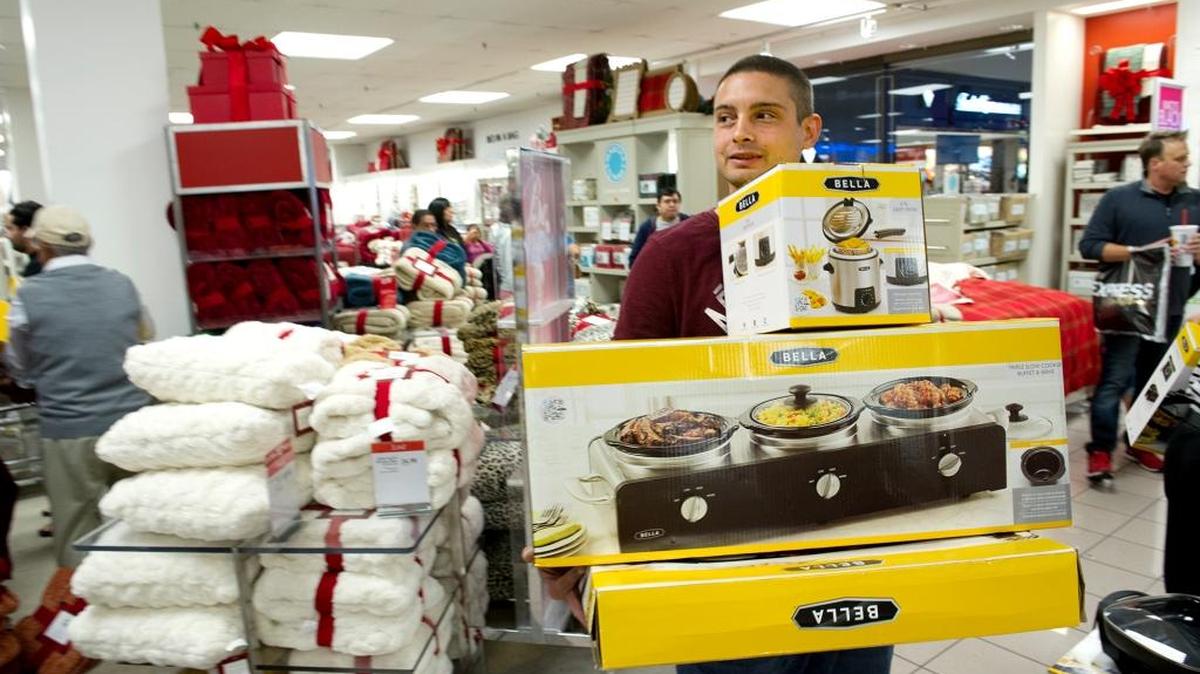 Daniel Butler picks up some “door busters” in Macy’s at Vintage Faire Mall during Black Friday shopping in Modesto on Nov. 29, 2013.