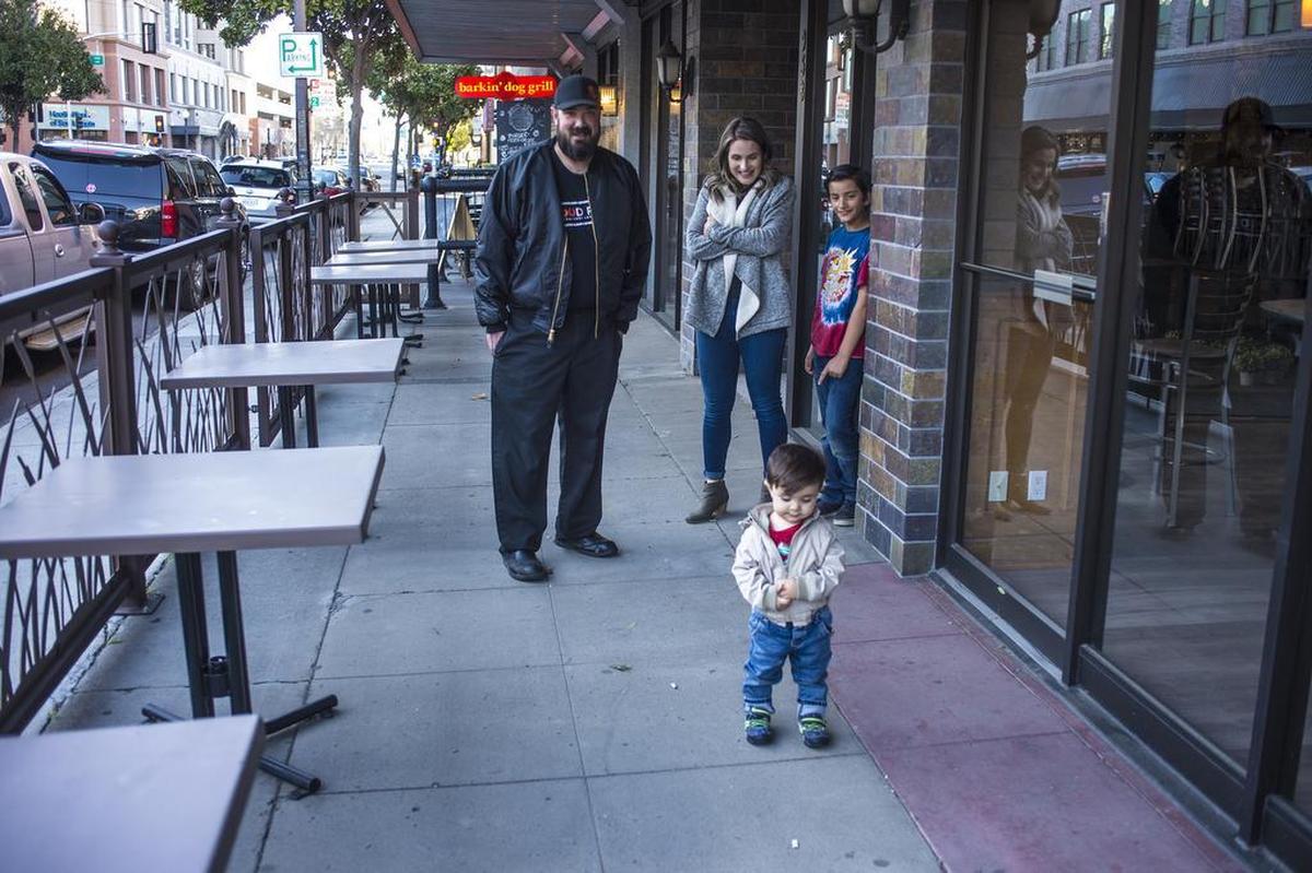 Hank and Ashley Olson watch as their 1-year-old son August Olson plays on the patio of the old Cobblestone Bakery in downtown Modesto, Calif. Feb. 22, 2019.
