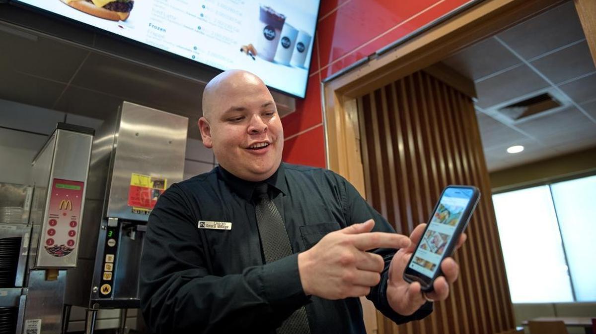 General Manager Diego Gutierrez demonstrates the Uber Eats app at McDonalds restaurant in Modesto, Calif., Tuesday, July 17, 2018.