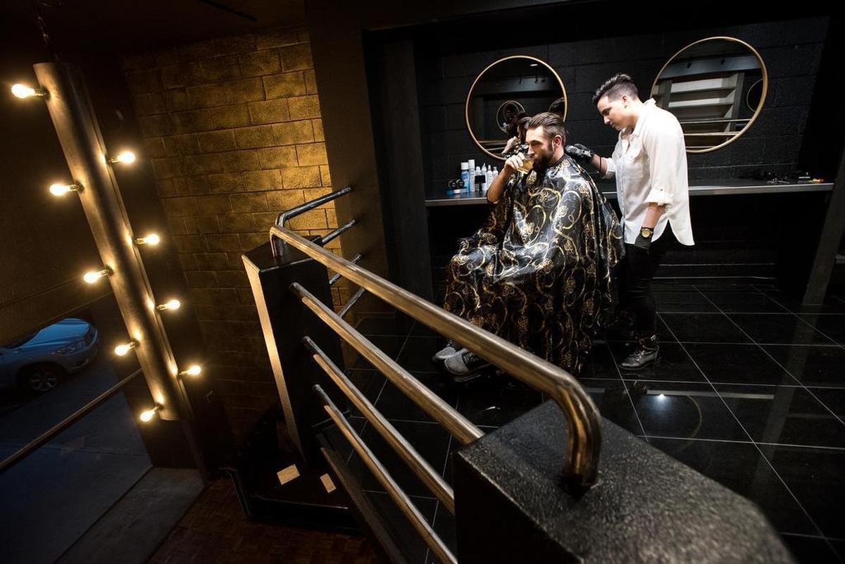 Courtney Warda cuts the hair of Nic Venturini at Blades and Bottles in Modesto, Calif., Friday, Jan. 25, 2019.