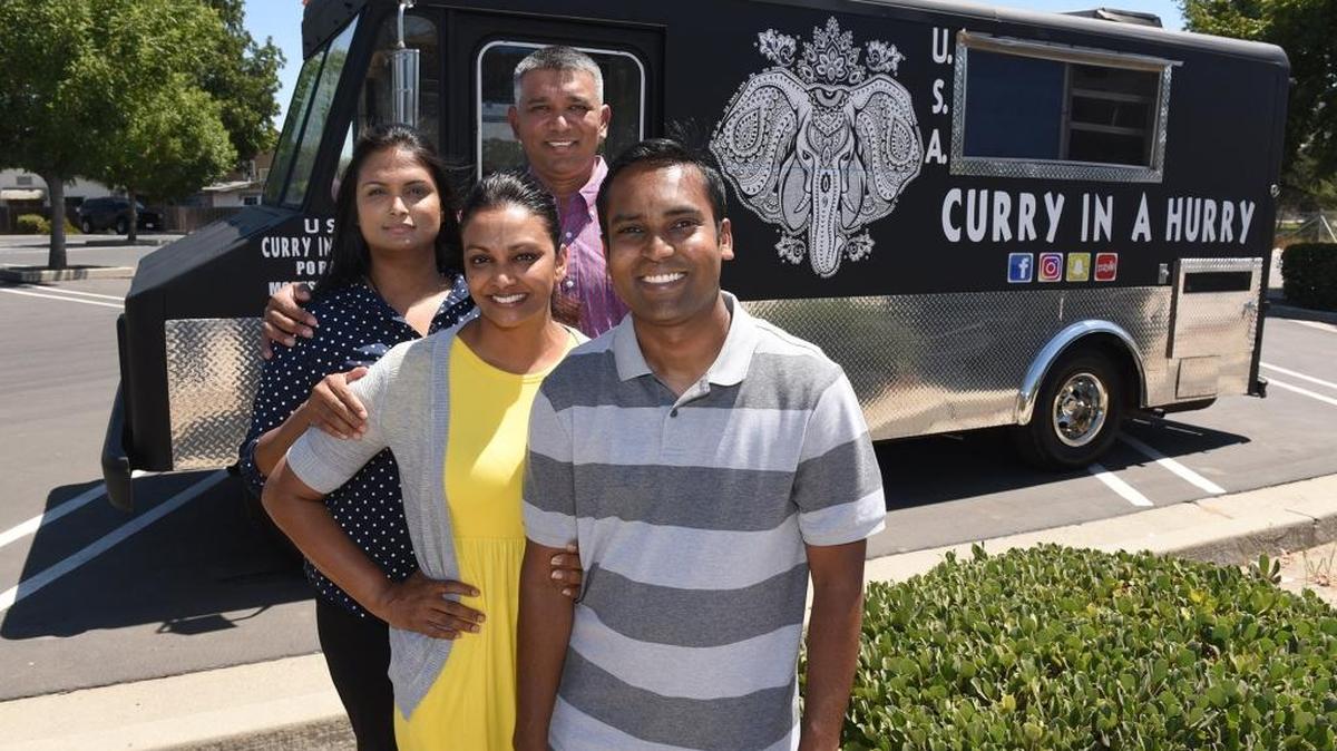 Pranesh (right) and Arti Narayan (yellow) are pictured with Shoblin and Roneel Chandra (back center) on Tuesday afternoon July 24, 2018 near their food truck Curry In A Hurry in Modesto, Calif. Curry In A Hurry will soon being serving up Indian Food in the parking lot of The Revival Center.