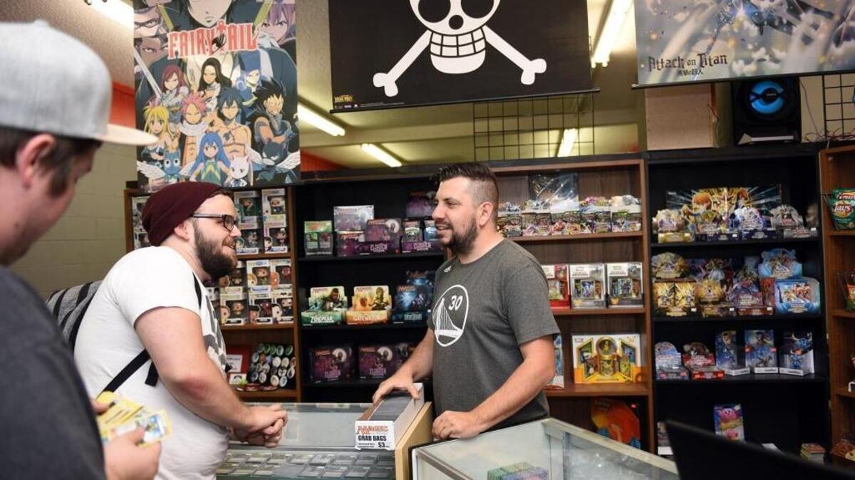Bryan Noriega, center, talks to customer Keana Macke on Thursday, Sept. 22, 2016, at Utopia Games and Collectibles on Tully Road in Modesto, Calif.