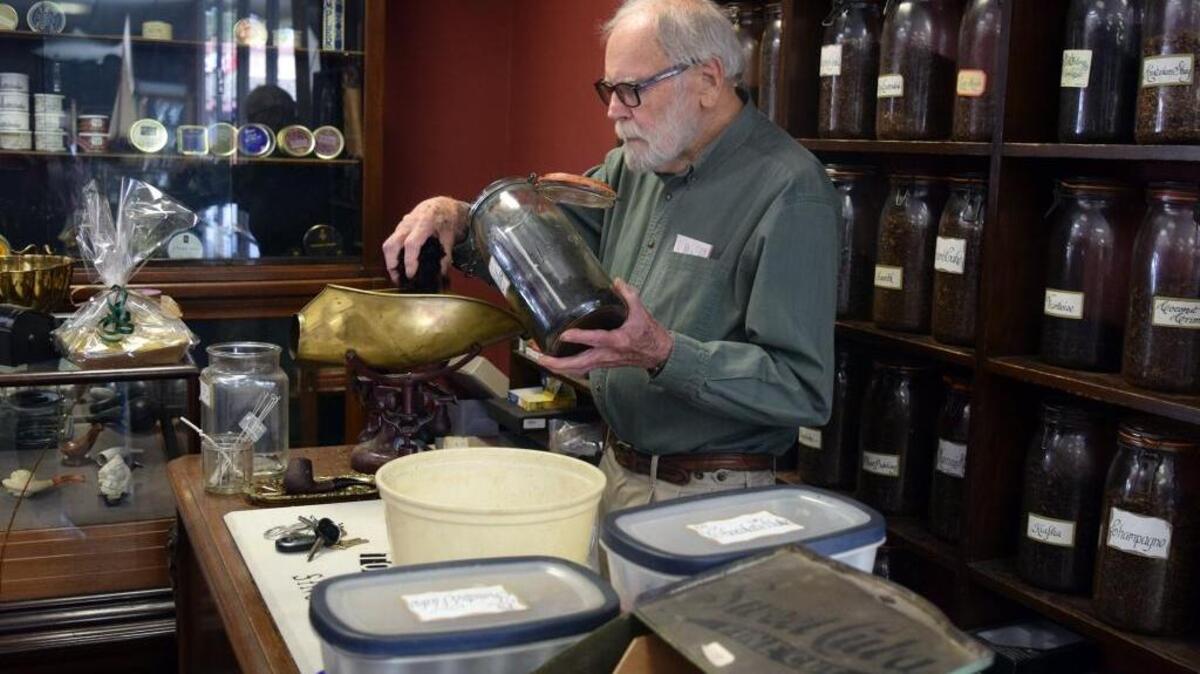 Ed Crosby measures out tobbaco at E. CrosbyTobacconist and Outfitter, which is closing after 48 years in business in Modesto. Crosby is pictured (05-05-17).