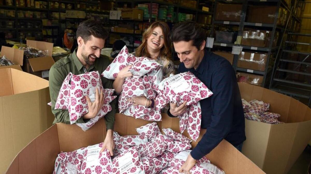 From left, Jay, Hilary and Rodney Zwahlen hold orders ready to be shipped Tuesday, Jan. 19, 2016, at White Plum in Modesto.