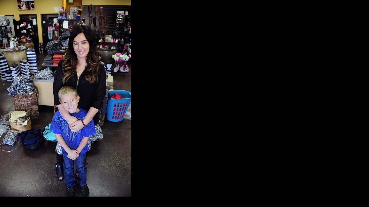 
Owner Darlene Dover and her son Kason, 8, are pictured in their store Envy on Monday morning in Atwater.
