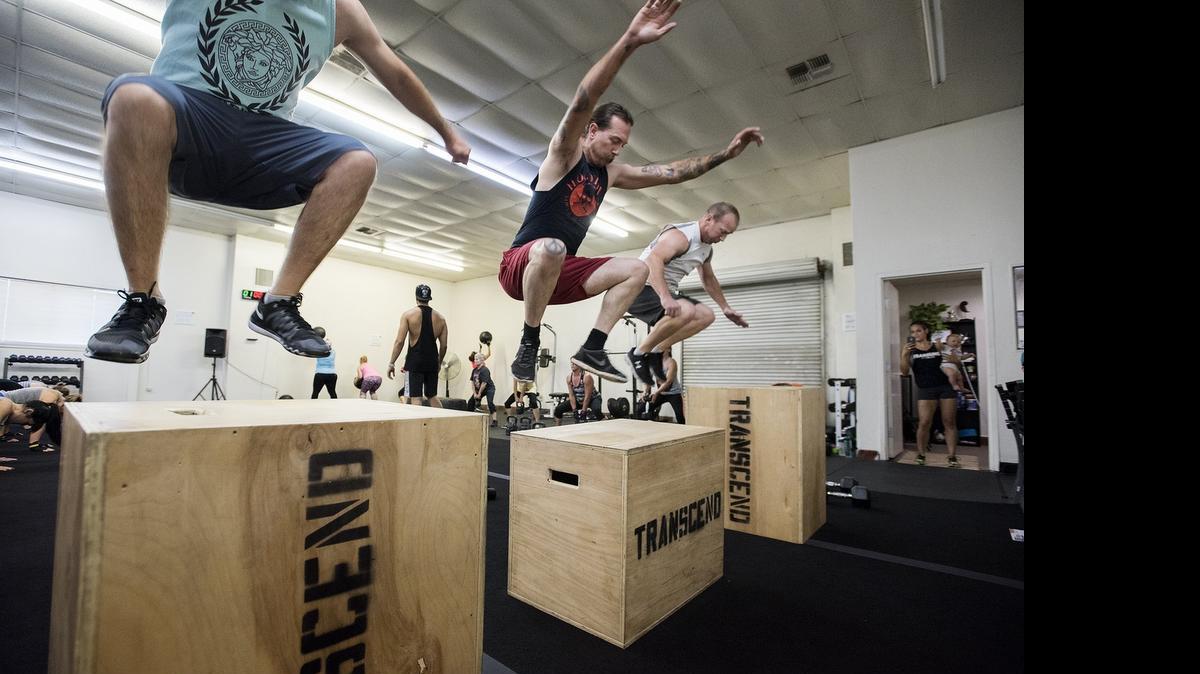 
People work out during a boot camp session at Transcend Fitness in Modesto last month. 
