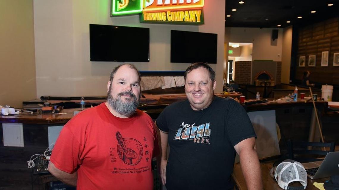 Middagh Goodwin (left) and Rich Hodder with St. Stan’s are pictured Friday morning (07-07-17) on 11th Street, in downtown Modesto, Calif. St. Stan’s will be in the former Sandude Brewing location. The iconic Modesto microbrewery will be restarted and have food at the site.