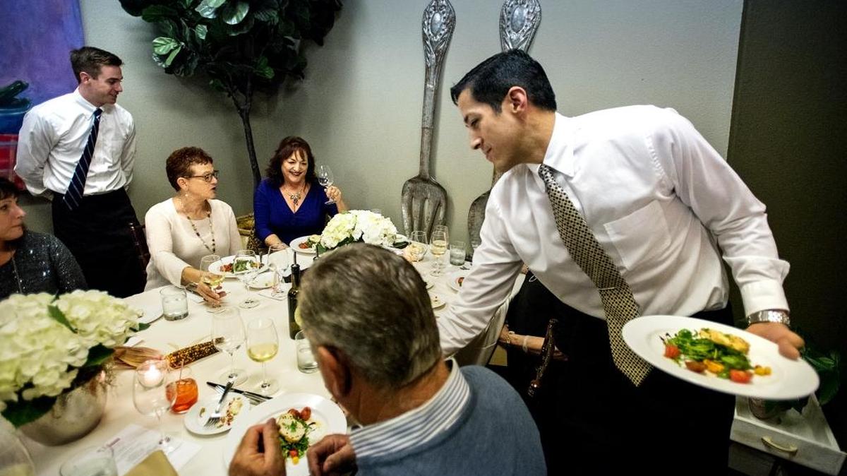 Server Paul Manzano brings out Insalata Burrata during a “pop-up dinner” at the Verona catering space in Modesto, Calif., on Thursday, Oct. 27, 2016.