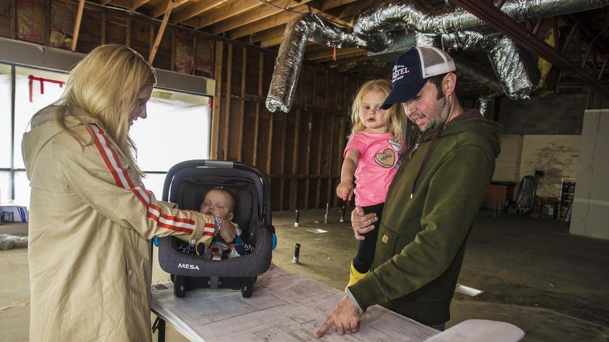 Matt Soderstrom speaks about the plans for his new artisan butcher shop, The Village Butcher, with help from his daughter Reagan, 3, as wife Stacy checks in on their 4-month-old baby Blake, on Saturday, March 23, 2019, at McHenry Village in Modesto. Soderstrom, a Modesto native, plans to open the full service butcher shop and deli in May.