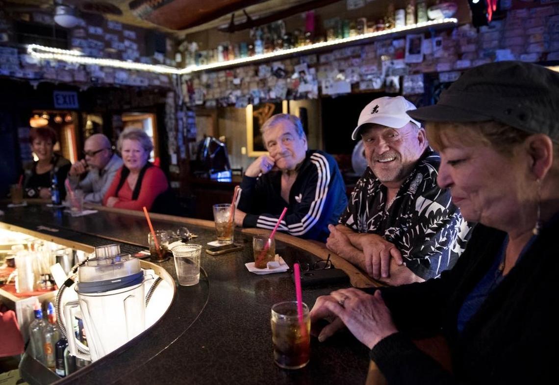 Terry Sparks, middle, and Al Clark, left, talk with manager Diane Marcuerquiaga at Minnie’s in Modesto on Saturday, Jan. 6, 2018.