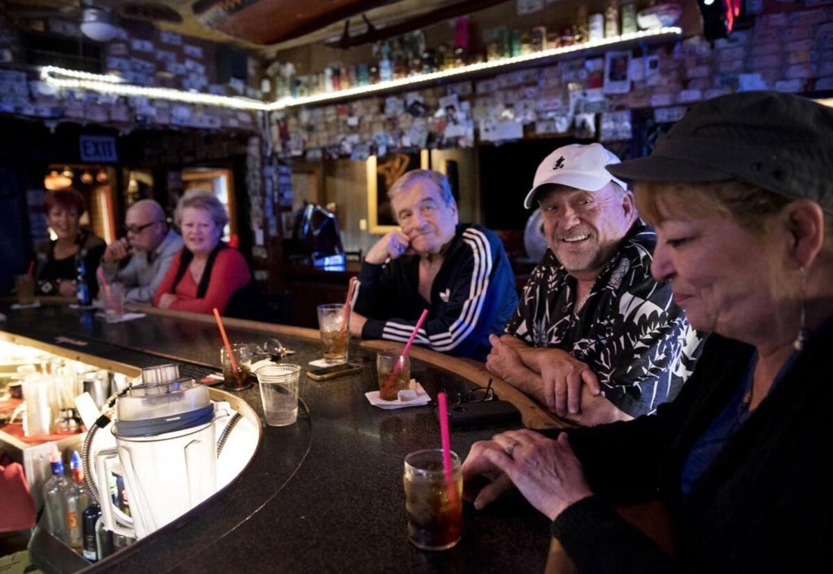 Terry Sparks, middle, and Al Clark, left, talk with manager Diane Marcuerquiaga at Minnie’s in Modesto on Saturday, Jan. 6, 2018.