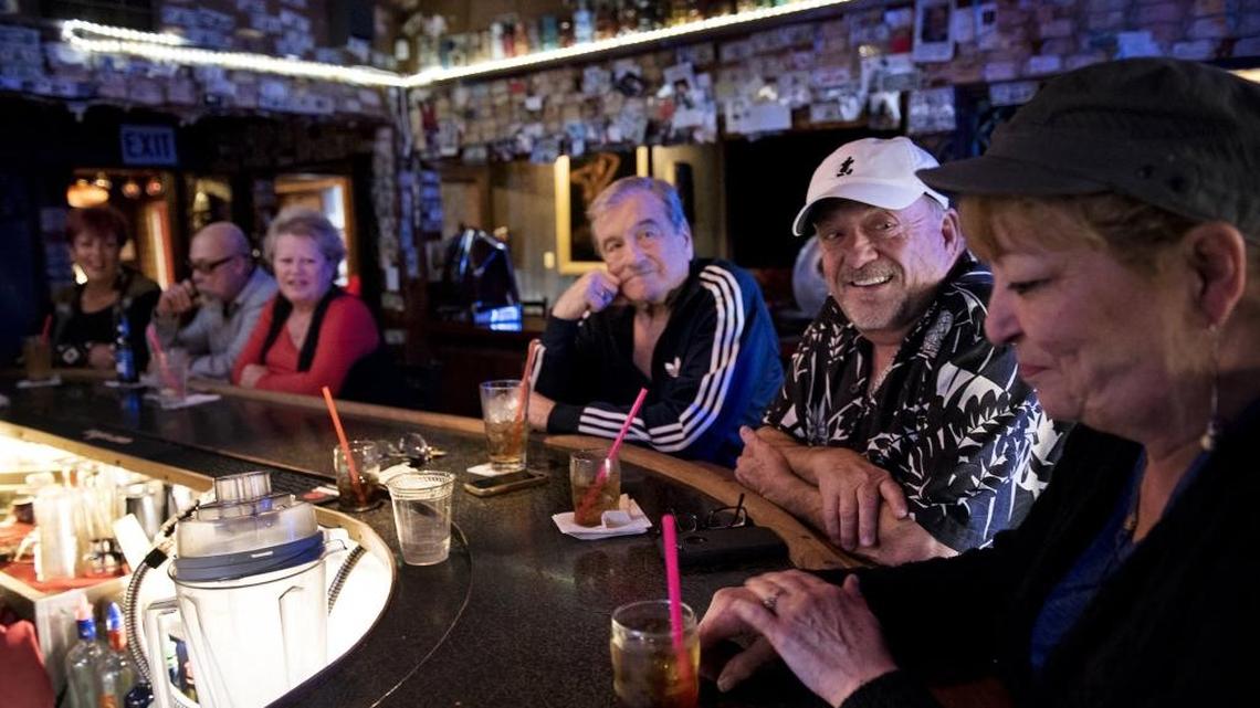 Terry Sparks, middle, and Al Clark, left, talk with manager Diane Marcuerquiaga at Minnie’s in Modesto on Saturday, Jan. 6, 2018.