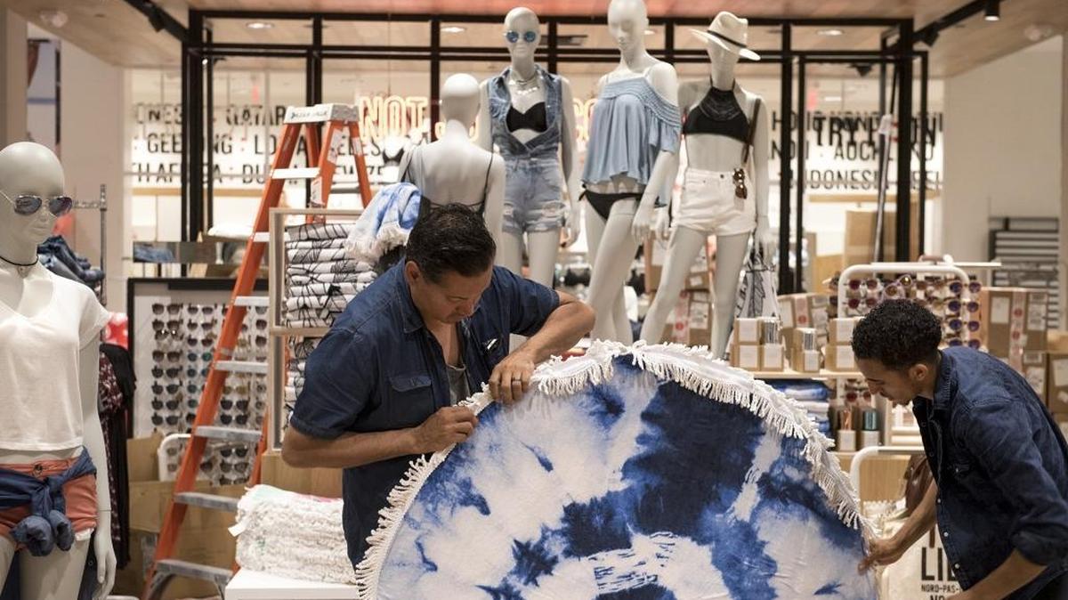 Regional visual manager John Mendoza, left, and manager Selemon Mesmer prepare the Cotton On apparel store for a soft opening at Vintage Faire Mall in Modesto, Calif., on Wednesday, May 11, 2016.