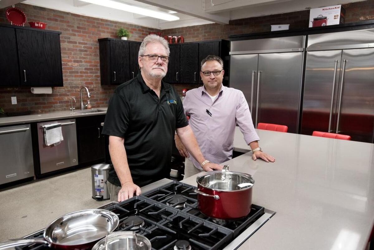 Owner Ron Winter, left, and Sam Garrett, director of of flooring and home construction, stand inside the demonstration kitchen at Direct Appliance in Modesto, Calif., on Wednesday, Sept. 19, 2018.
