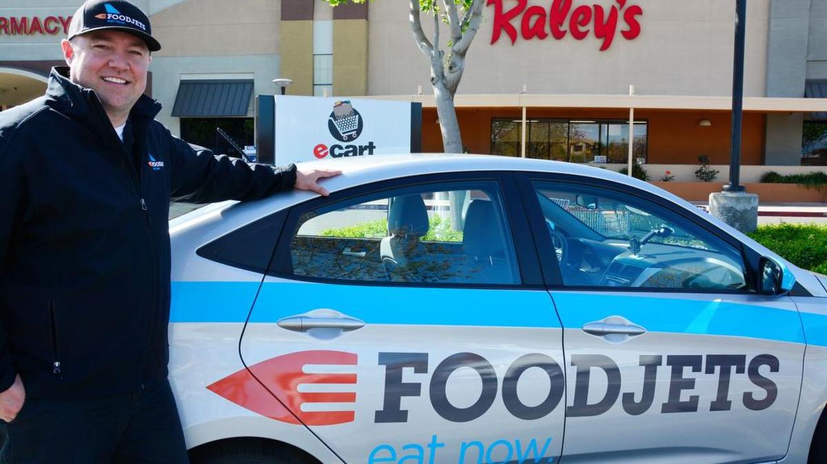 Modesto-Stockton Food Jets owner Charles Duke shows off one of the logo delivery cars for the online food delivery service. FoodJets recently switched to an app-based model and services much of Modesto, Riverbank and Salida.
