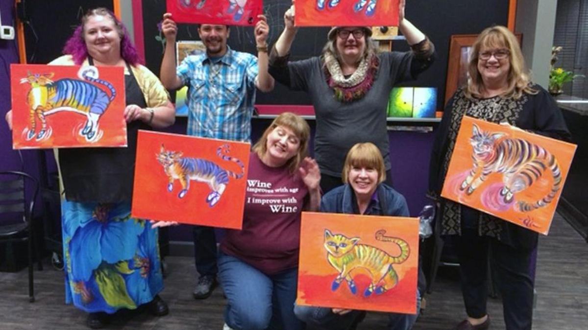 The new Art Time & Sip Wine Studios in downtown Modesto, Calif. opened in March of this year. Artists with their paintings are pictured in the business.