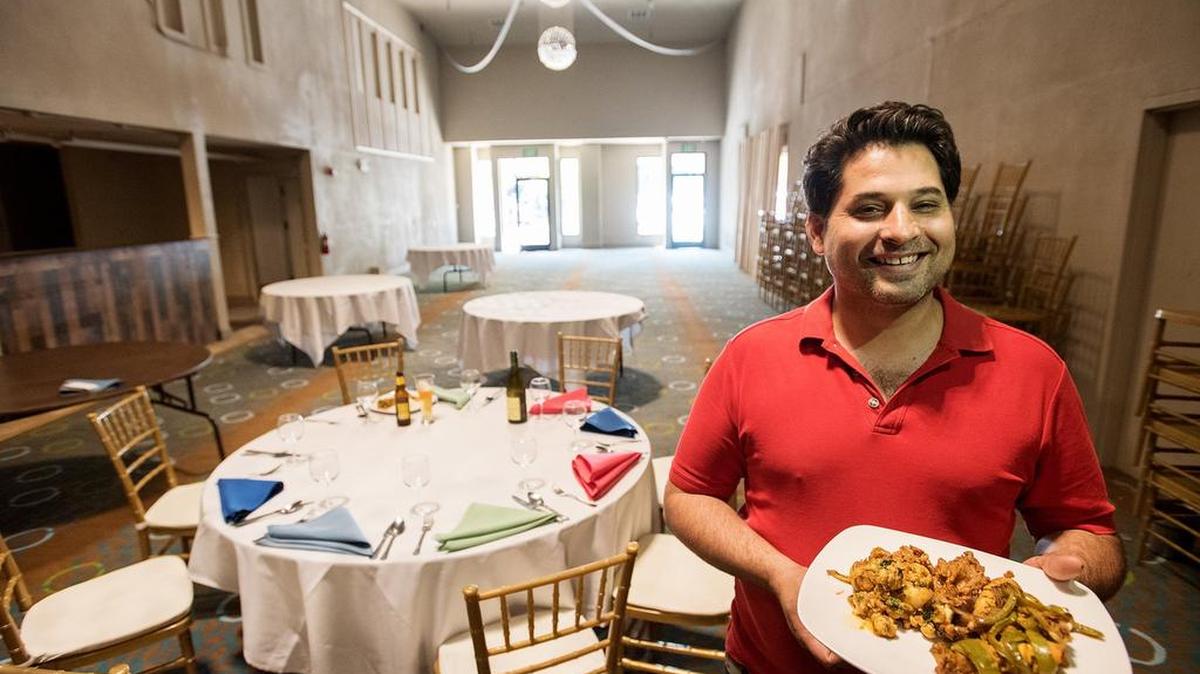 Gurinder S. Khaira holds a plate with Tandori Chicken and vegetables in their newly renovated banquet space at Monsoon Restaurant in Modesto, Calif., September 5, 2018.