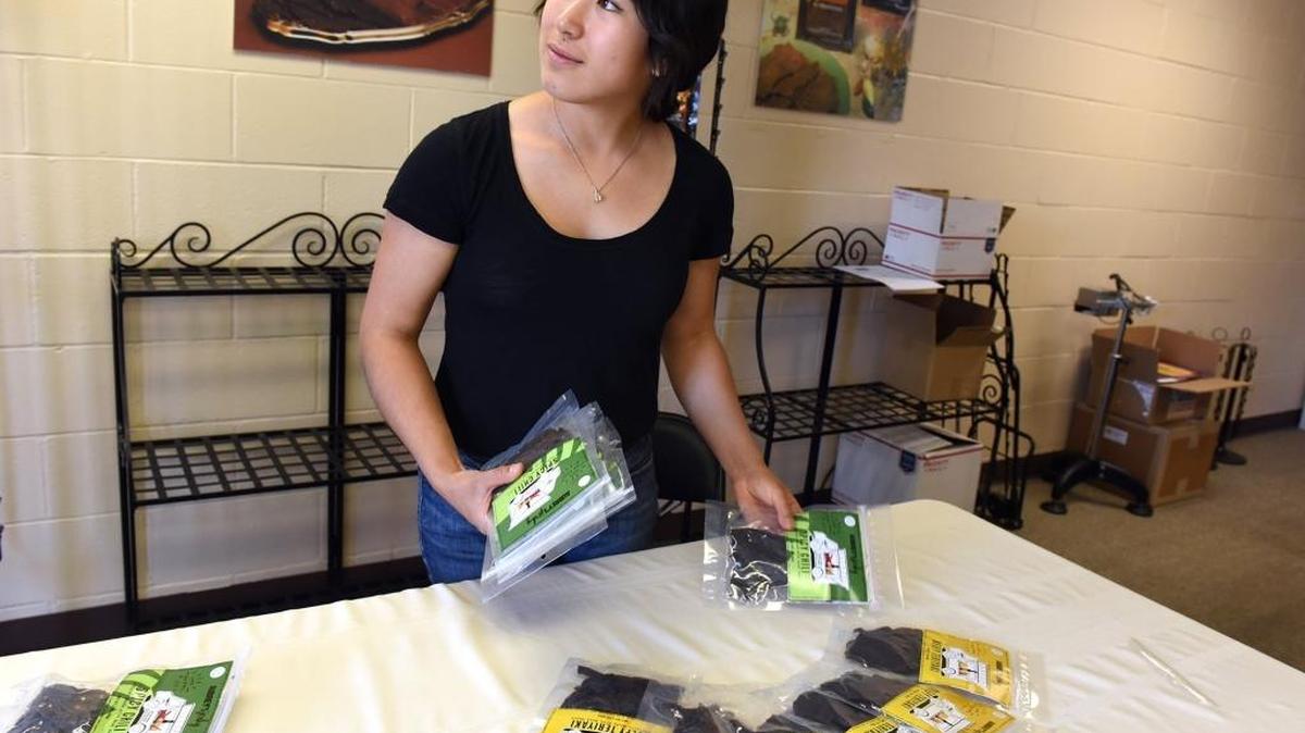 Aubrey Lim sets out her jerky at Snackmasters in Hilmar, Calif., last week. Lim won the Buyer’s Choice Award at the Fresno Food Expo for her jerky, made of beef hearts.