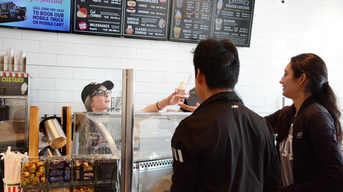 The new Rita's Italian Ice has opened in Turlock's Monte Vista Crossings shopping center on Thursday, Feb. 8, 2018. Autumn Corry-South serves customers Melissa Soriano and Luis Aguilar.