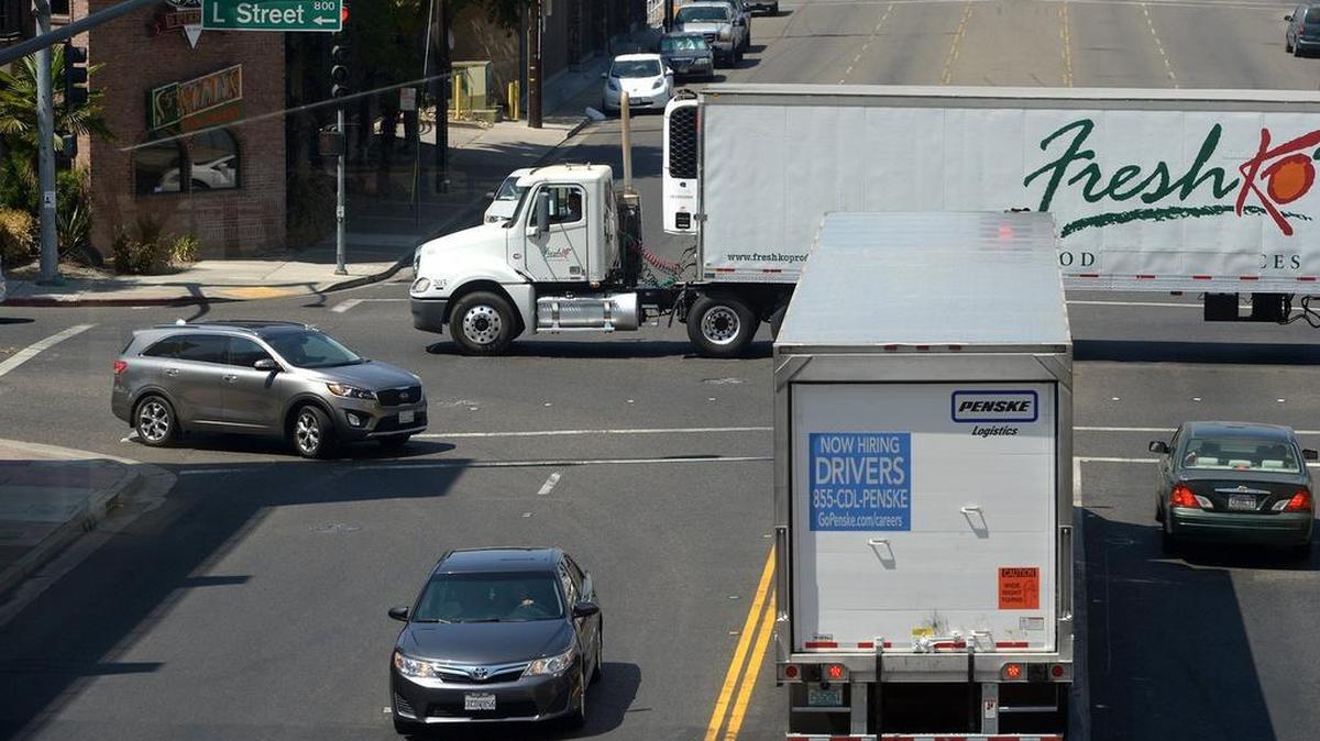 
Trucks drive on Ninth and K streets Friday in downtown Modesto. Tractor-trailer driver was the occupation with the most help-wanted ads in Stanislaus County in July, according to the state, with 701.
