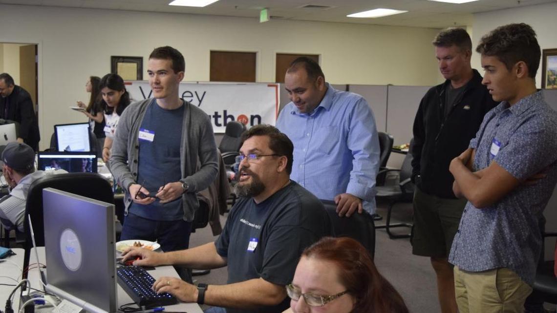 ModSpace hosted the Valley Designathon on Saturday to develop or redesign websites and an app for three Modesto nonprofit organizations. The 10-hour competition was held at the Kirk Lindsey Center on 10th Street. Among those watching teams at work are, third from right, Jose Sabala of South Modesto Partnerships and, second from right, Darin Jesberg of the Dry Creek Trails Coalition.