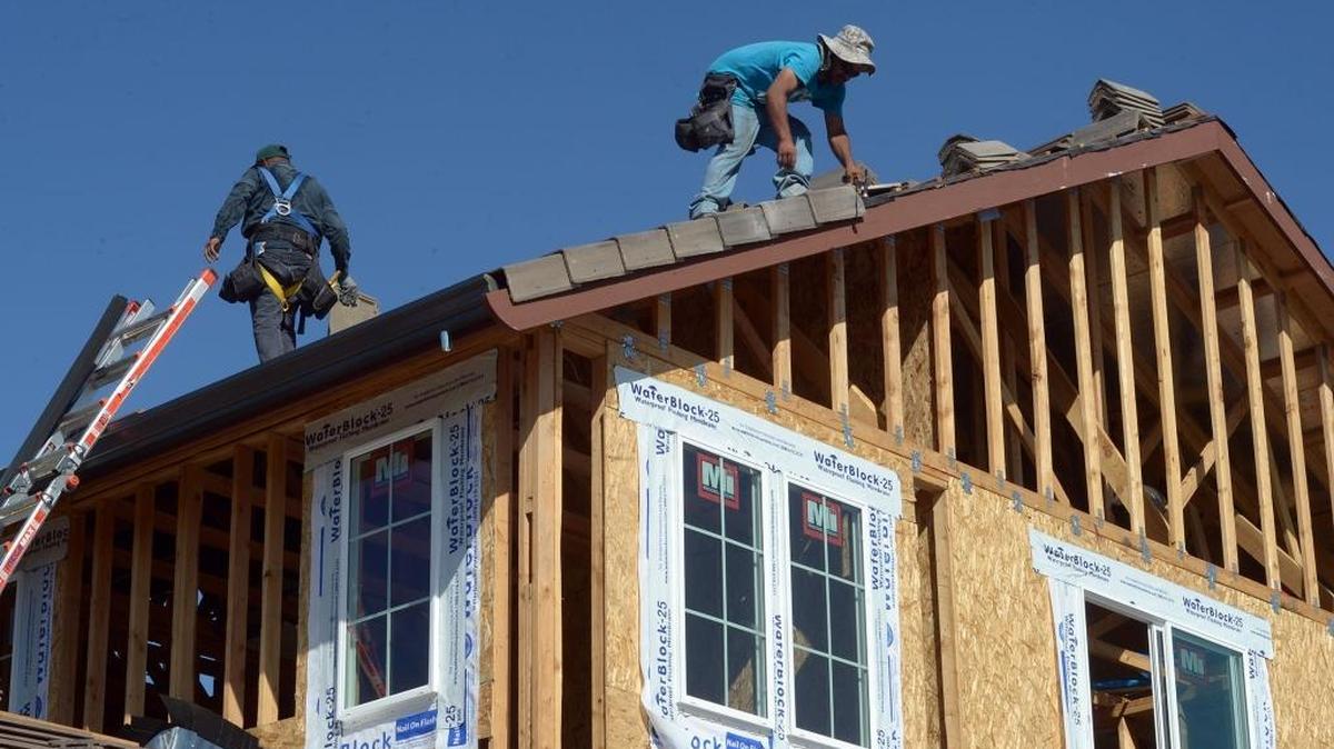 Jose Magana works on the roof of a new home in 2015 in the Summerfield subdivision at North Berkeley Avenue and Field Drive in Turlock, Calif. 