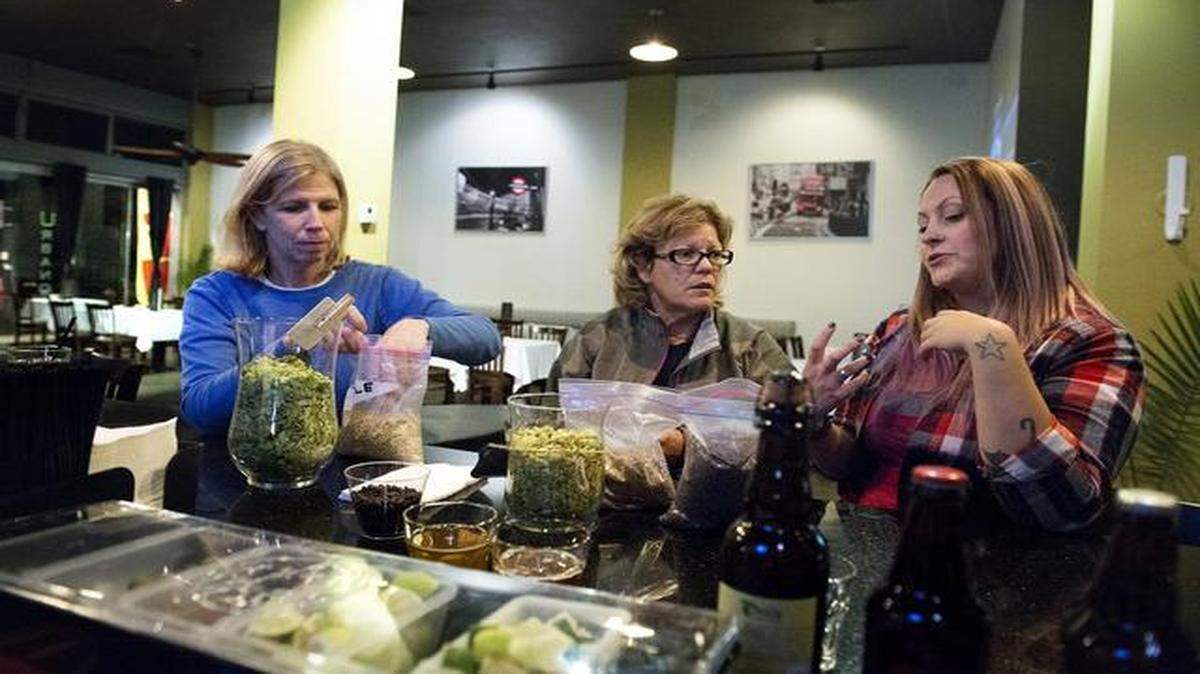 
Sierra Nevada Brewing Co. sales representative Aubrey Ushing, right, explains beer ingredients and the brewing process to Mary Duffy, left, and M.J. Misailidis, center, both of Ceres, during a beer tasting event at Ubano California Bistro in Modesto on Thursday.
