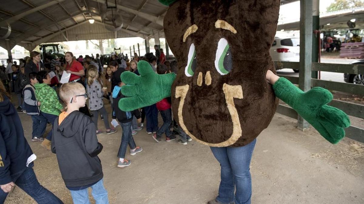 Natural Resources Conservation Service mascot Sammy Soil greets students during Ag Edventure at the Stanislaus County Fairgrounds in Turlock, Calif., on Friday, Oct. 14, 2016.