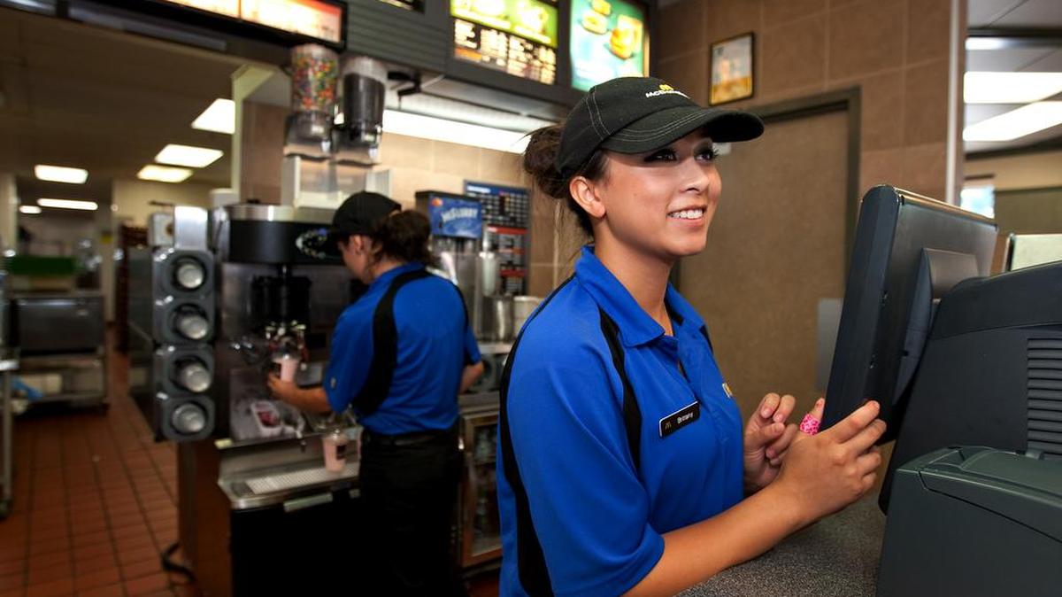Brittany Peralta, 17, of Salida, takes orders at the counter during her shift at McDonald's in Modesto, Calif., in 2012.