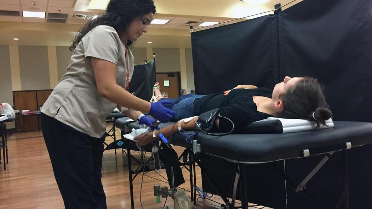 
Phlebotomist Niria Adams draws blood from Ceres resident Rachel Stochl at the Ceres Community Center on Monday during the Battle of the Badges blood drive, a friendly competition between the city’s police and fire departments to benefit Delta Blood Bank. Stochl cast her donor vote for the Fire Department.
