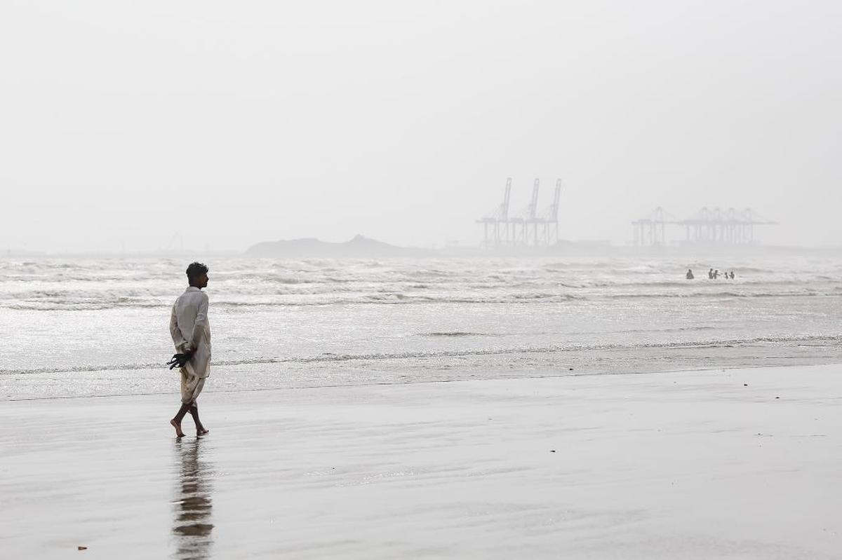 A man walks along Clifton Beach in the port city of Karachi, Pakistan.