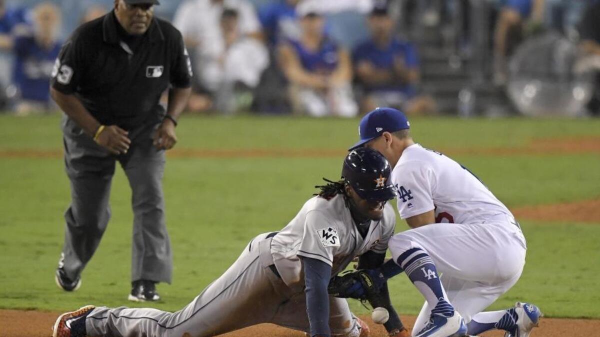 Houston Astros’ Cameron Maybin, left, steals second past Los Angeles Dodgers Austin Barnes during the 11th inning of Game 2 of baseball’s World Series Wednesday, Oct. 25, 2017, in Los Angeles.