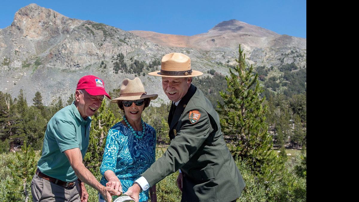 
Tioga Road Rededication Ceremony-- A ceremony was held Tuesday (07-28-15) in Yosemite National Park to rededicate the Tioga Road. The highest road crossing of the Sierra at 9,945 feet, was originally dedicated on July 28, 1915. Pictured here (L to R) are Jerry Edelbrock, VP, Yosemite Conservancy, Laura Bush, Former First Lady and Co-Chair National Park Service Centennial, and Yosemite National Park Superintendent Don Neubacher. A "christening bottle" was broken over a ceremonial rock to reenact the original dedication, exactly 100 years ago. Photo by Al Golub/Yosemite Conservancy
