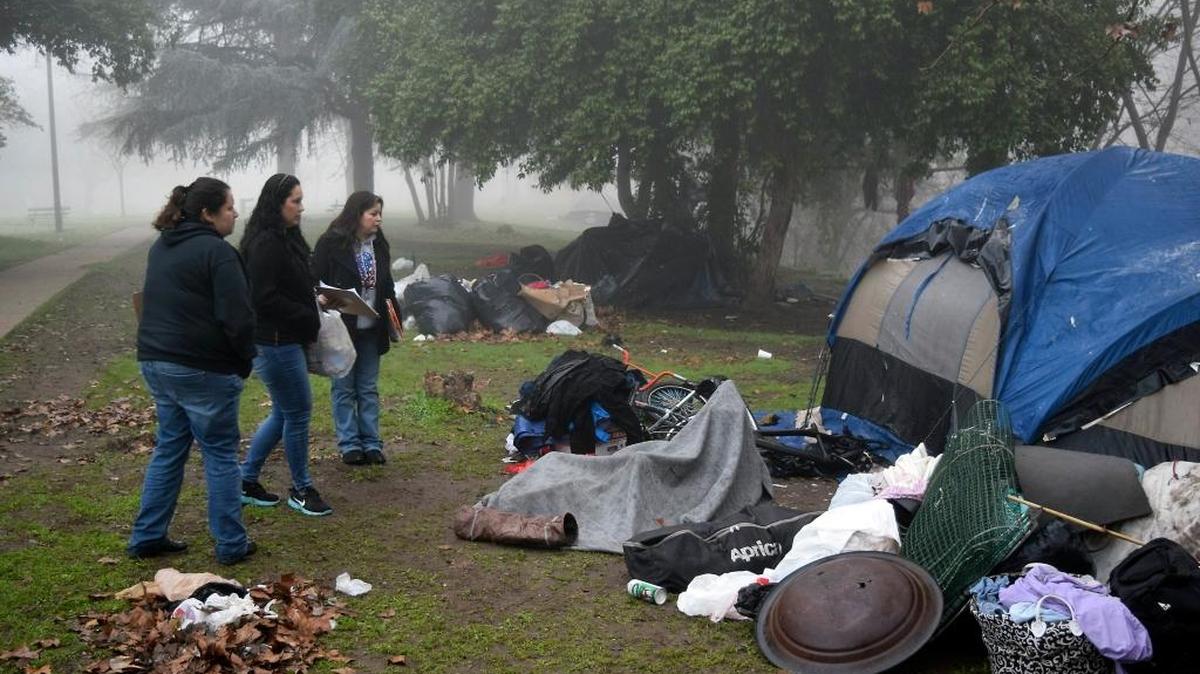 Teresa Olvera, Erika Aguilera and Nora Martinez with Telecare approach a campsite in Beard Brook Park in Modesto during the Point in Time Count of the homeless on Jan. 28, 2016.
