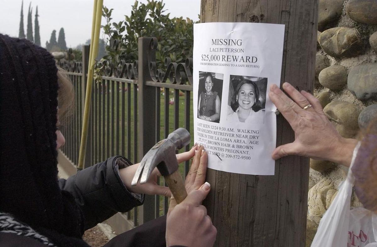 Friends and family members of Laci Peterson, who disappeared on Christmas Eve, post flyers on Scenic Drive in Modesto, Calif. in 2002.