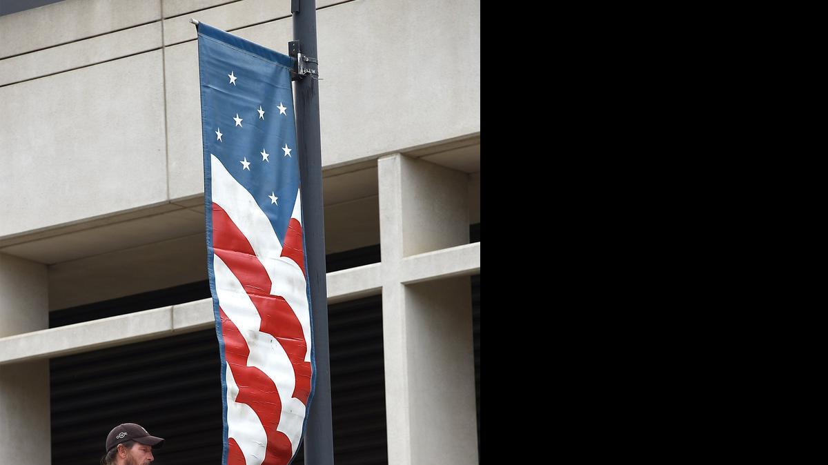 
John Braxton, an employee of Reese’s Installation, puts up a Fourth of July banner in downtown Modesto on Thursday morning, ahead of the city’s annual patriotic celebration.
