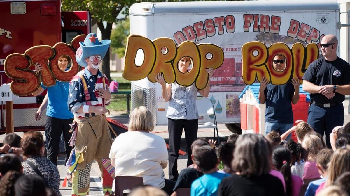Fire clown Tex explains to Orchard Elementary School students the concept of “stop, drop and roll” during the Modesto Fire Department’s fire prevention program last fall.