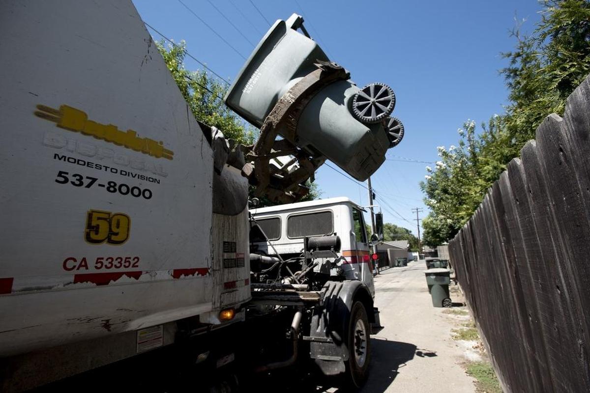 Bertolotti Disposal collects garbage and green waste in an alley behind Princeton Avenue in Modesto, Calif., on Thursday, June 30, 2016.