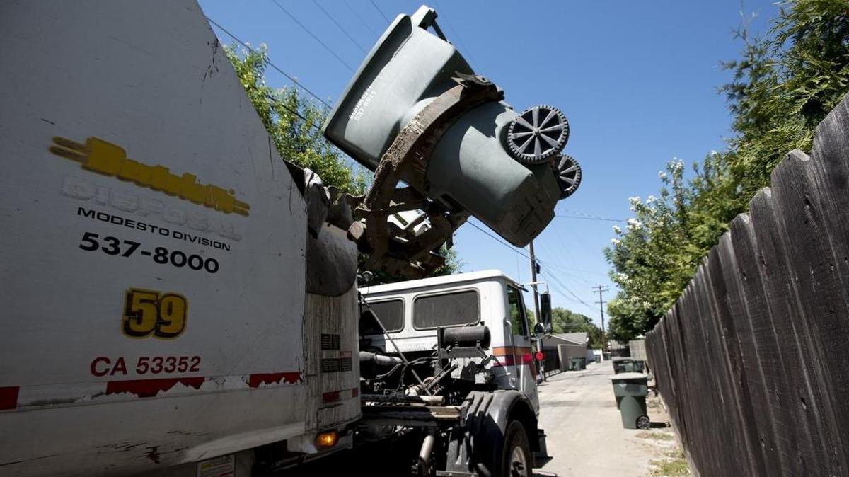 Bertolotti Disposal collects garbage and green waste in an alley behind Princeton Avenue in Modesto, Calif., on Thursday, June 30, 2016.