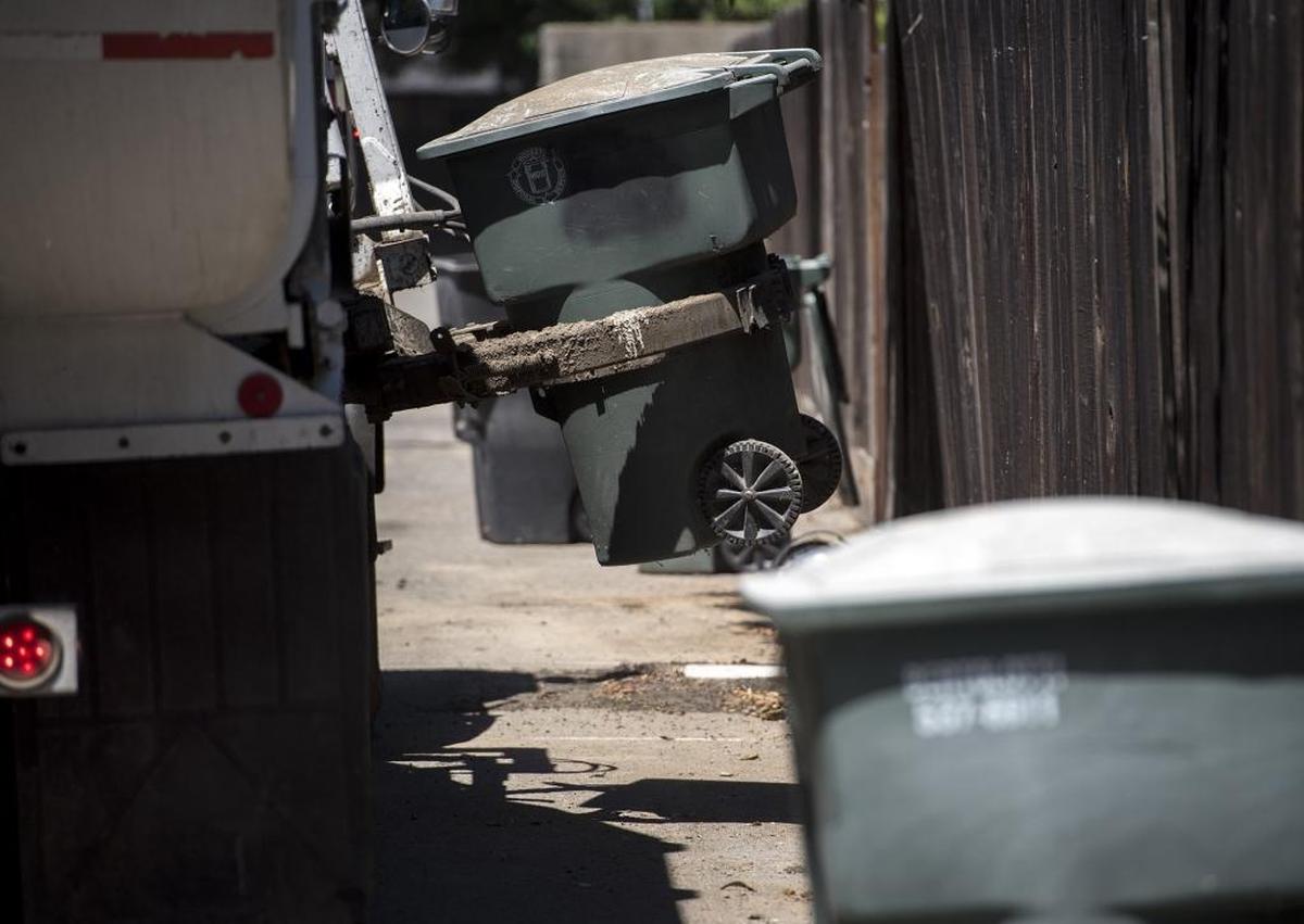 Bertolotti Disposal collects garbage and green waste in an alley behind Princeton Avenue in Modesto, Calif., on Thursday, June 30, 2016.