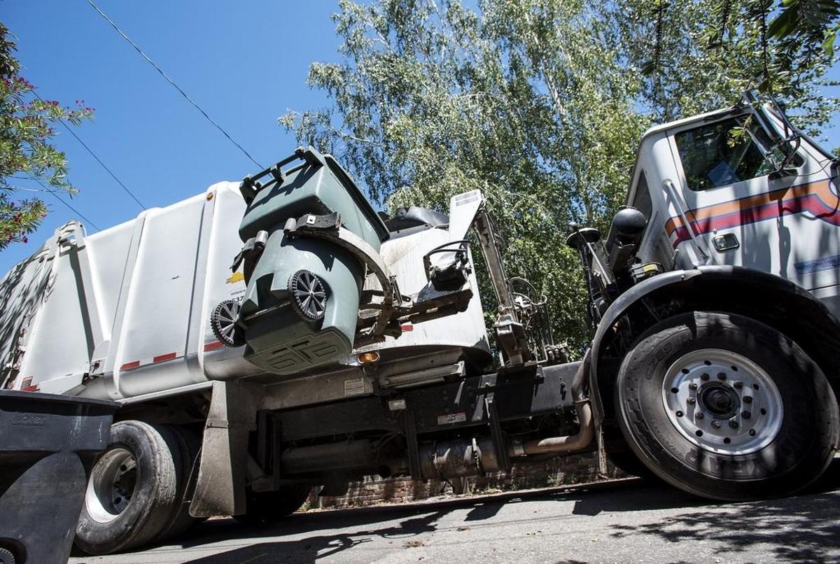 Bertolotti Disposal collects garbage and green waste in an alley behind Princeton Avenue in Modesto, California, on Thursday, June 30, 2016.