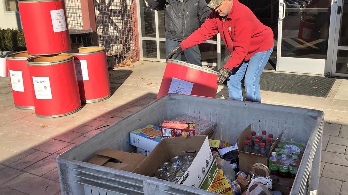 Salvation Army employees Ralph Garcia, right, and Keith Dawson pick up food donated by students and staff at Gurnick Academy of Medical Arts on Stoddard Road in north Modesto on Wednesday, Dec. 16, 2015.