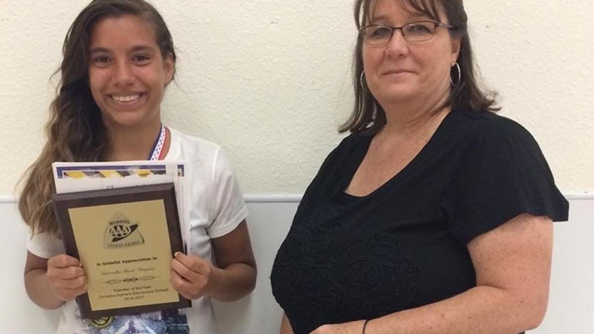 Sipherd Elementary School sixth-grader Gabriella Marie Vasquez receives her award for Patroller of the Year from Suzi Calvillo, sales and service associate at the AAA Modesto branch.